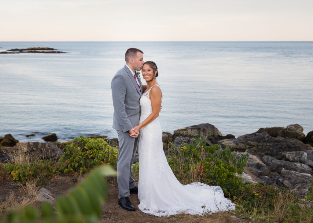 Bride and Groom standing near the ocean